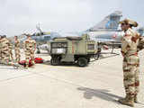 French air force crew stand around French Mirage 2000 fighter jets 