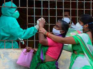 A woman (C) reacts as a health worker tries to collect her swab sample to test for the Covid-19 coronavirus AFP