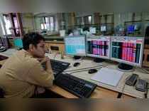 A broker monitors share prices at a brokerage firm in Mumbai