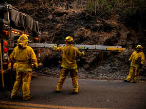 Fire Fighters with the South Lake Fire District work to extinguished small flare ups from the Glass Fire in Adobe Canyon, California on September 29, 2020 AFP