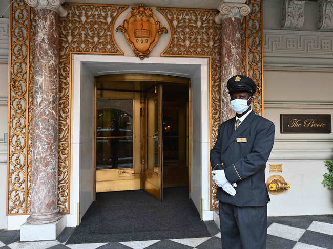 ​Doorman Isaac stands at the entrance to The Pierre, A Taj Hotel in New York City. ​