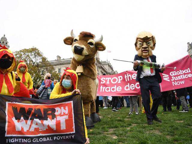 A mock syringe alongside activists