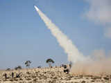 Libyan rebel fighters fire a rocket towards pro-Kadhafi forces