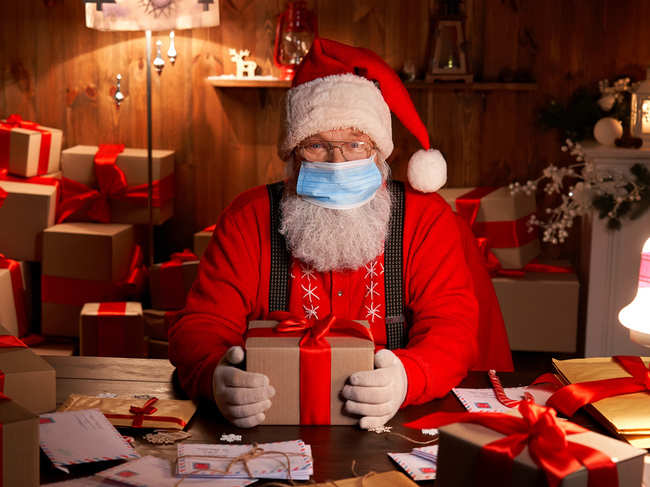 This is Santa Claus in the Coronavirus Age, where visits are conducted with layers of protection or online.