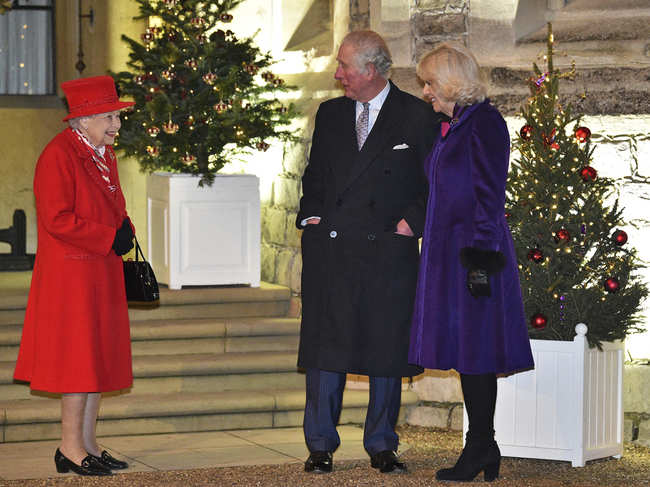 The 94-year-old monarch, wearing a bright red outfit, was joined by her eldest son and heir Prince Charles and his wife Camilla.