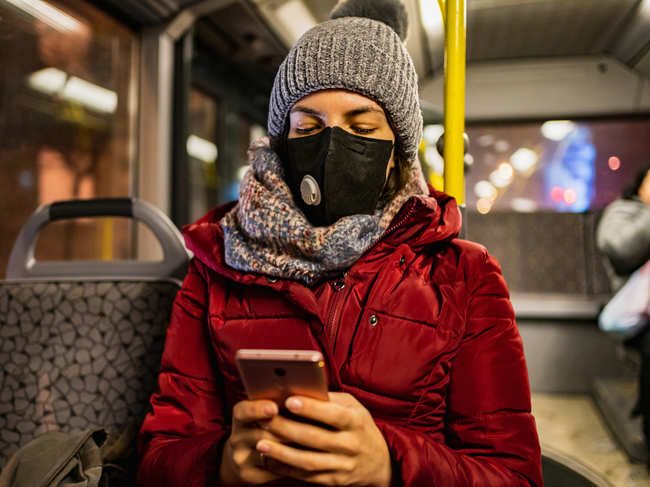 coronavirus-winter-mask-bus-travel-woman_iStock