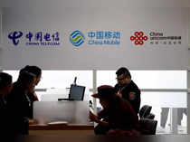 FILE PHOTO: Signs of China Telecom, China Mobile and China Unicom are seen during the China International Import Expo at the National Exhibition and Convention Center in Shanghai
