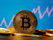 FILE PHOTO: A representation of virtual currency bitcoin is seen in front of a stock graph