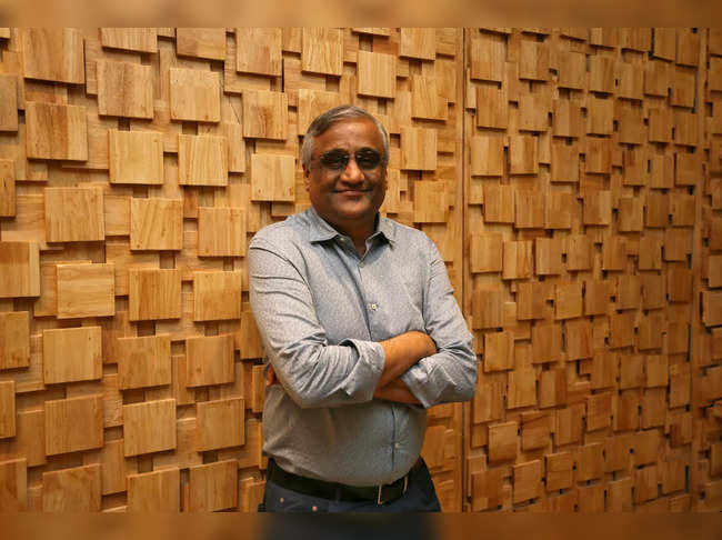 FILE PHOTO: Kishore Biyani, CEO and founder of India's Future Group poses after the inauguration of Foodhall, a premium lifestyle food superstore by the Future Group, store in Mumbai