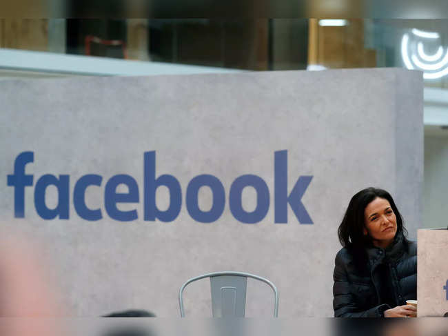FILE PHOTO: Sheryl Sandberg, chief operating officer of Facebook, listens to a speeches during a visit in Paris