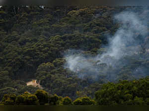 Emergency services can be seen fighting a bushfire that is burning in the Cherry Gardens area in the Adelaide Hills