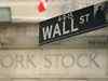 Wall Street closes on a mixed note, dollar advances on COVID-19 concerns