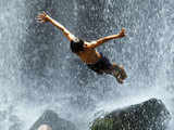 A boy jumps into the Llanos del Cortes waterfall