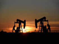 FILE PHOTO: Pump jacks operate at sunset in an oil field in Midland