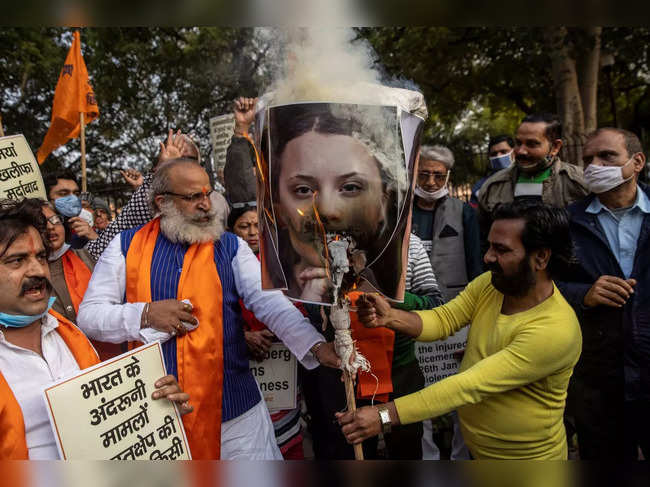 Activists from United Hindu Front burn an effigy depicting climate change activist Greta Thunberg to protest against the celebrities for commenting in support of protesting farmers, in New Delhi