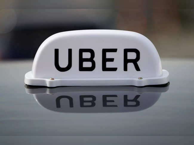 FILE PHOTO: The Logo of taxi company Uber is seen on the roof of a private hire taxi in Liverpool