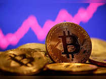 FILE PHOTO: A representation of virtual currency bitcoin is seen in front of a stock graph in this illustration