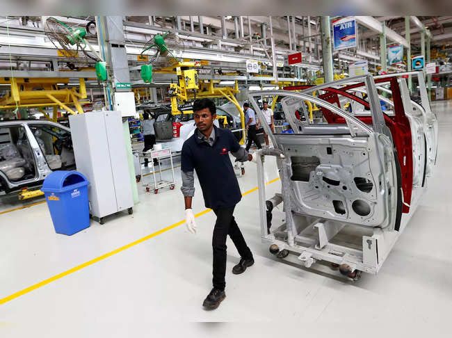FILE PHOTO: FILE PHOTO: An employee works inside the Mahindra & Mahindra manufacturing plant in Chakan