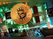 FILE PHOTO: Representation of the virtual currency Bitcoin is seen on a motherboard in this picture illustration