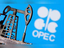 FILE PHOTO: A 3D printed oil pump jack in front of the OPEC logo