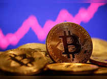 FILE PHOTO: A representation of virtual currency Bitcoin is seen in front of a stock graph in this illustration taken