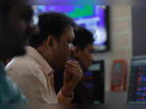 A broker reacts while trading at his computer terminal at a stock brokerage firm in Mumbai