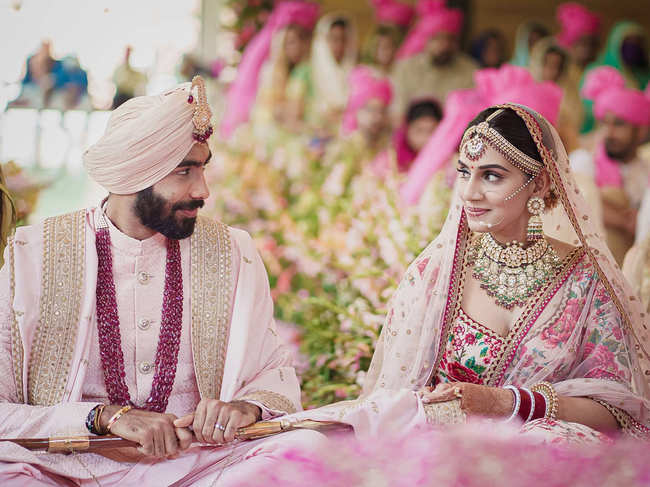 While Bumrah ​​looked dapper in a pink sherwani and gold embroidery, Ganesan was breathtaking in a floral, matching lehenga with minimal make-up.