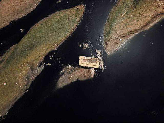 Brazil: ​A discarded sofa on the Tiete river