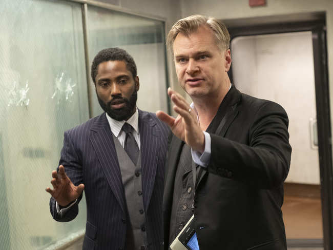 This image released by Warner Bros. Pictures shows John David Washing, left, with director Christopher Nolan on the set of 'Tenet.'