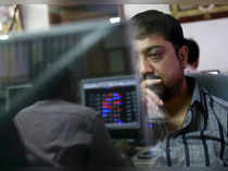 A broker reacts while trading at his computer terminal at a stock brokerage firm in Mumbai