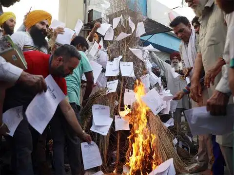 Burning farm law copies