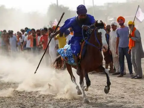 Nihang, or Sikh warrior, performs at Singhu border