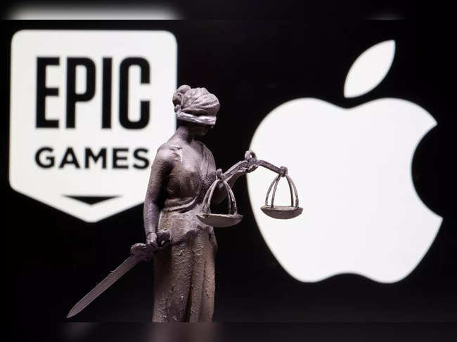 FILE PHOTO: 3D printed Lady Justice figure is seen in front of displayed Apple and Epic Games logos in this illustration photo
