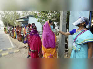 Jhargram: Voters undergo thermal scanning, as precaution against COVID-19, while...