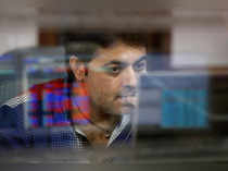 A broker reacts while trading at his computer terminal at a stock brokerage firm in Mumbai