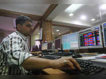 A broker trades on his computer terminal at a stock brokerage firm in Mumbai