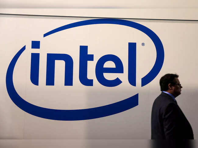 FILE PHOTO: A visitor passes an Intel logo at the Mobile World Congress in Barcelona