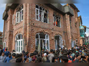 Shopian: People gather near the partially damaged mosque where two militants wer...