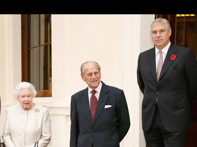 File photo of November 2015: Queen Elizabeth II (L) accompanied by Prince Philip (C), Duke of Edinburgh and Prince Andrew, Duke of York at Buckingham Palace in London, England.