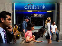 FILE PHOTO: Pedestrians walk past the facade of a Citibank building in New York