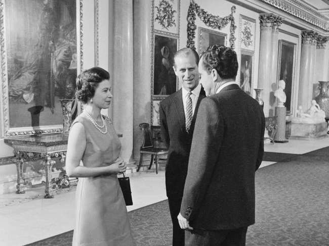 File photo of February 1969: ​US President Richard Nixon (R), Queen Elizabeth II (L) and Prince Philip (C) tour the Marble Hall in Buckingham Palace in London, Britain.