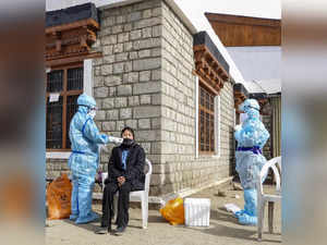 Leh: Medics collect sample from a woman for COVID-19 test, in Leh, Ladakh. (PTI ...