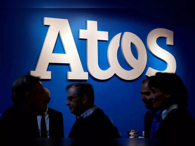 FILE PHOTO: People walk in front of the Atos company's logo during a presentation of the new Bull sequana supercomputer in Paris