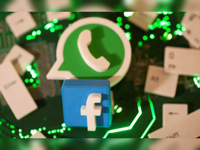 Illustration of 3D printed Facebook and WhatsApp logos and keyboard buttons on a computer motherboard