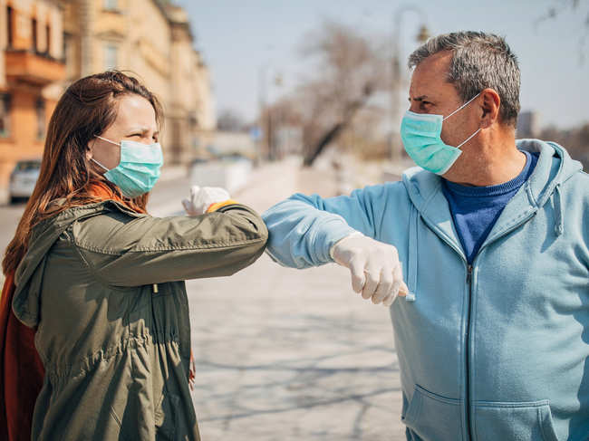 coronavirus-elbow-bump-hug_iStock