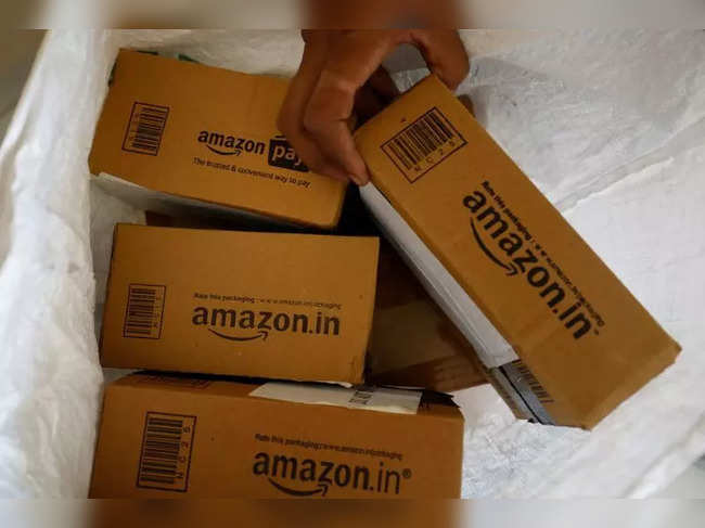 FILE PHOTO: A worker sorts delivery packages in a van outside an Amazon facility in Ahmedabad