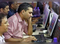 Brokers trade at computer terminals at stock brokerage firm in Mumbai