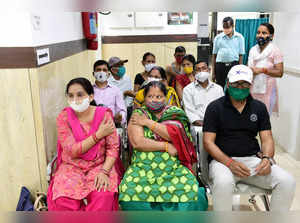 New Delhi: People wait after being vaccinated with Covishield vaccine, during a ...