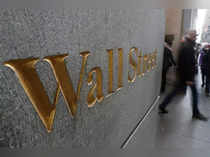 FILE PHOTO: A street sign, Wall Street, is seen outside New York Stock Exchange (NYSE) in New York City, New York