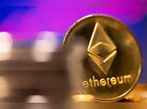 A representation of virtual currency Ethereum are seen in front of a stock graph in this illustration